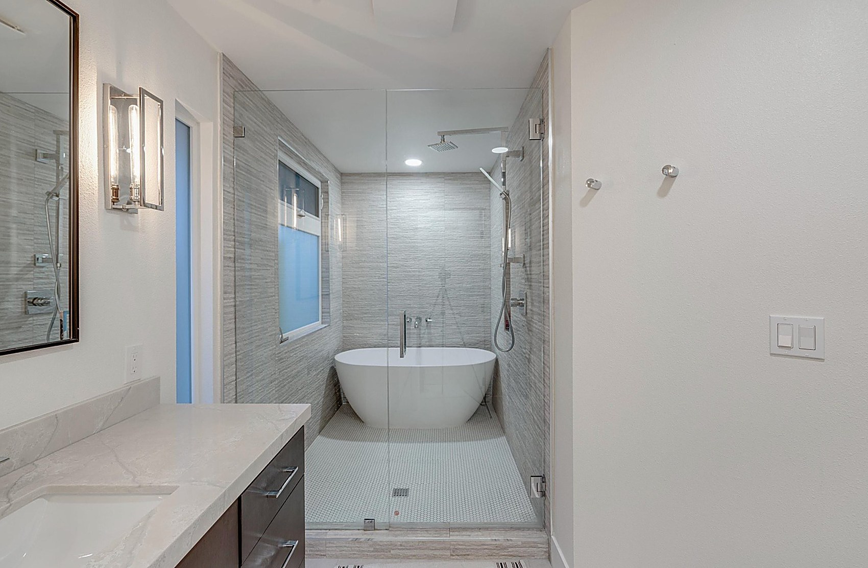Master bath finished — freestanding tub in glass-enclosed wet room