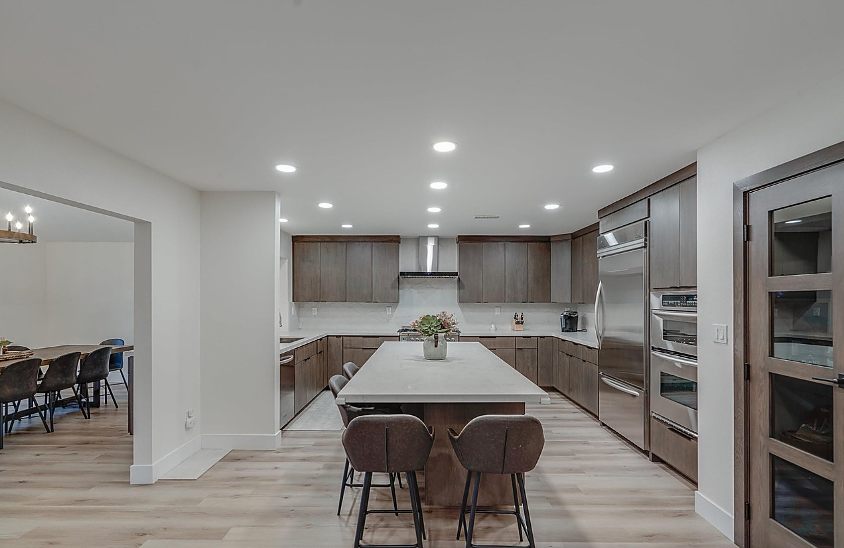 La Jolla kitchen wide view — stained walnut cabinets, quartz island