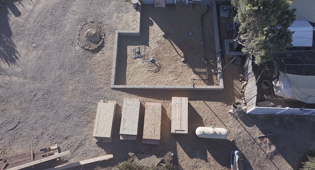 Aerial of completed foundation with materials staged