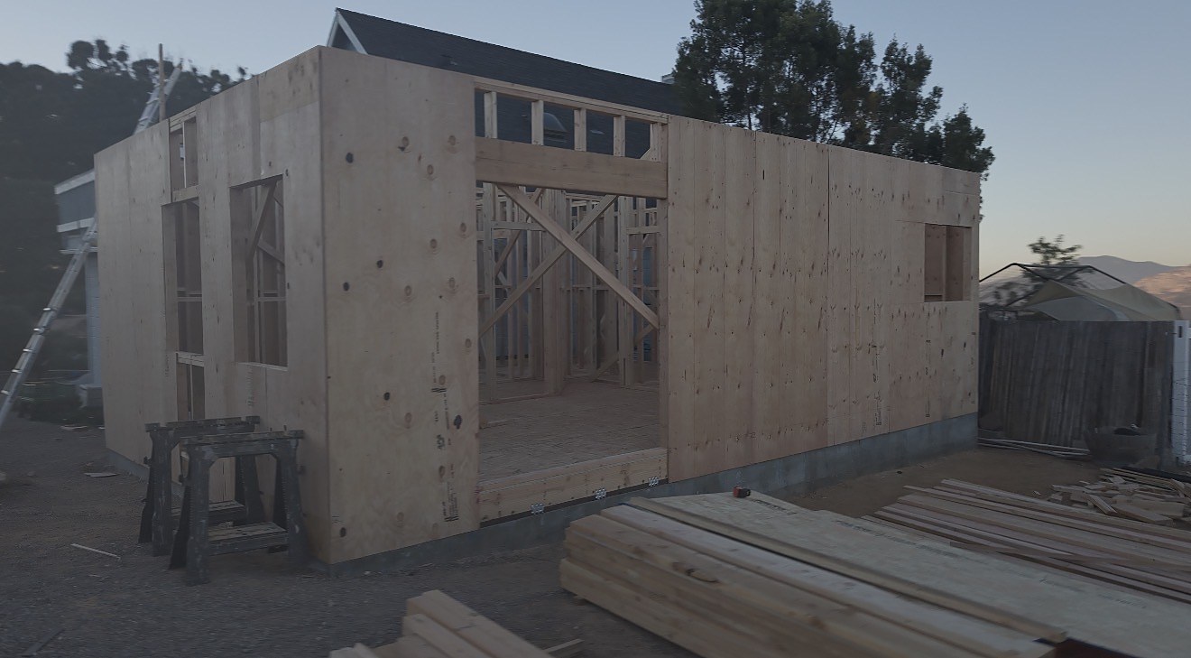 Sheathed walls rising at dusk