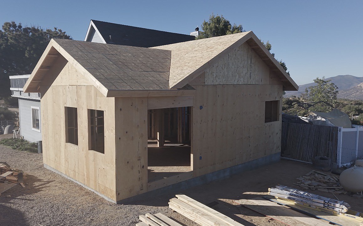 Corner view showing both gable ends and roof shingles installed