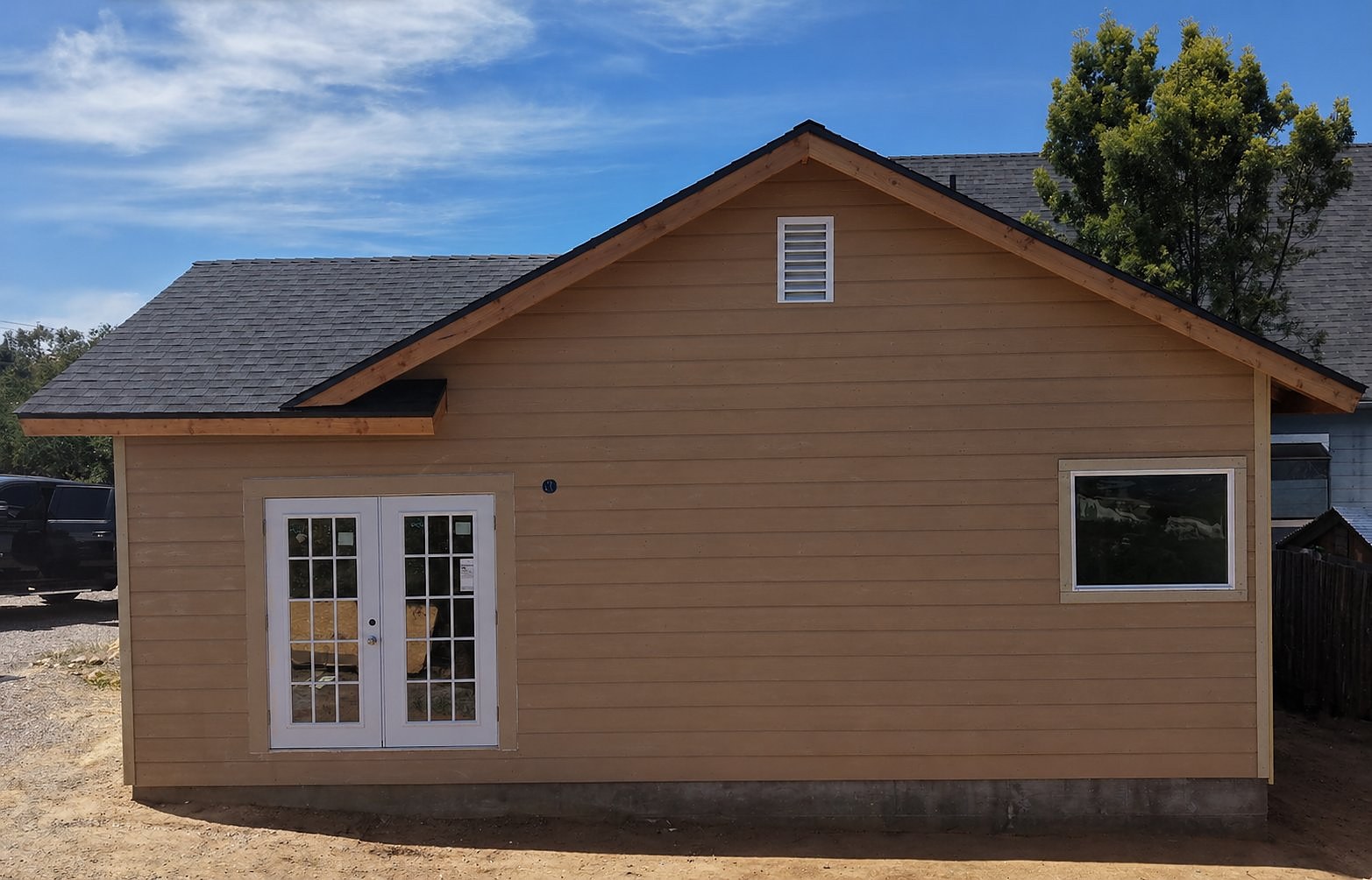Finished exterior siding with French doors installed